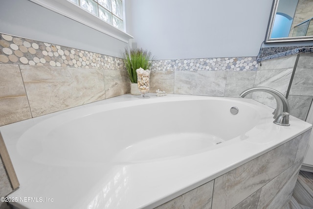 bathroom featuring a relaxing tiled tub