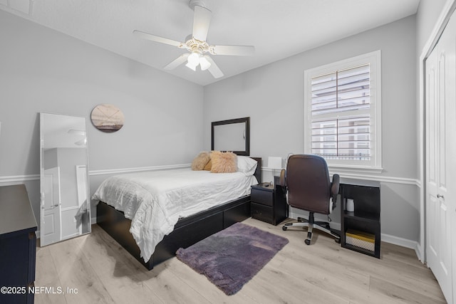 bedroom with ceiling fan, light wood-type flooring, and a closet