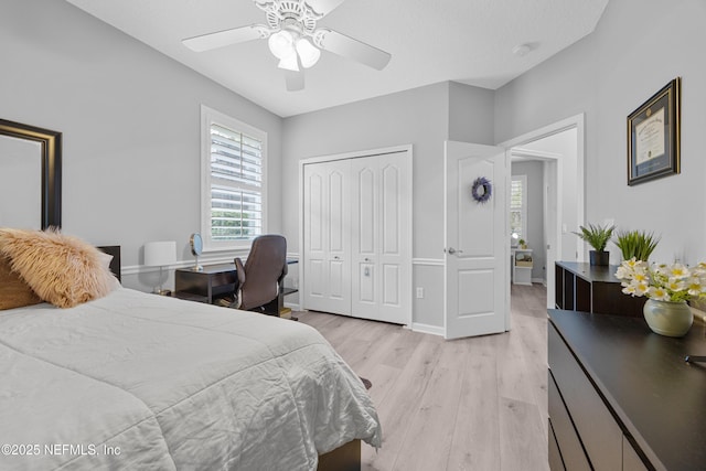 bedroom featuring ceiling fan, a closet, and light hardwood / wood-style flooring