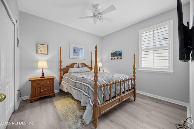 bedroom with a closet, ceiling fan, and light hardwood / wood-style flooring