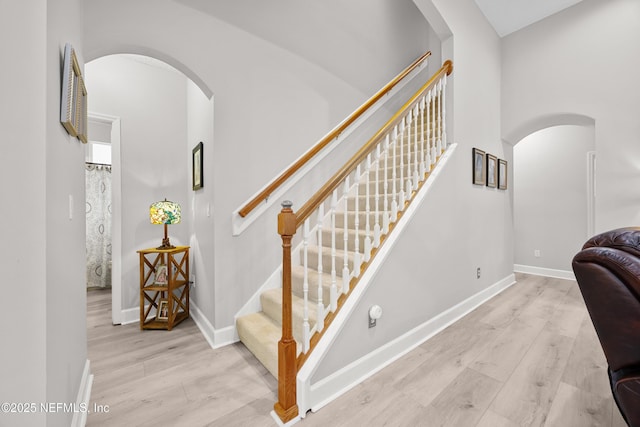 staircase with hardwood / wood-style floors