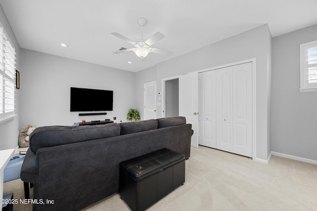 carpeted living room with ceiling fan