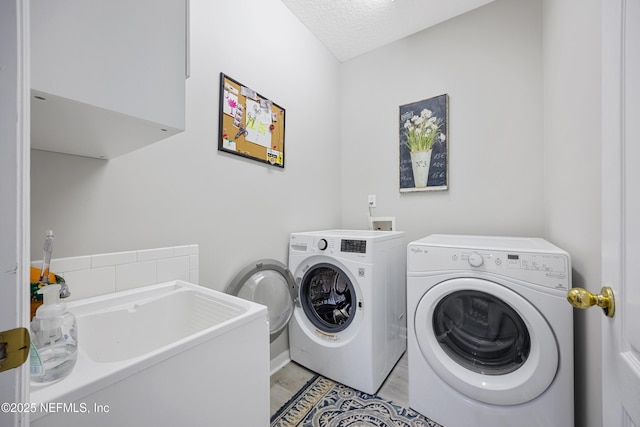 washroom with washer and dryer and sink