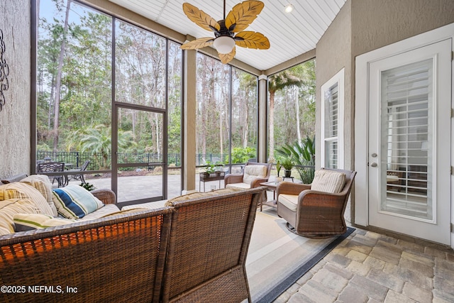 sunroom / solarium with ceiling fan and a healthy amount of sunlight