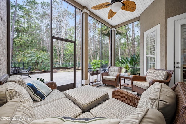 sunroom featuring a healthy amount of sunlight and ceiling fan