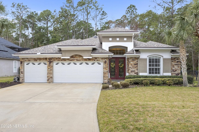 view of front of home with a garage, a front lawn, and french doors