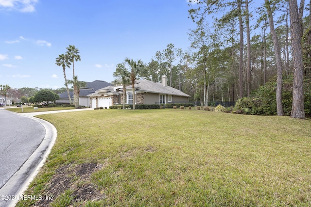 view of front of property featuring a garage and a front lawn