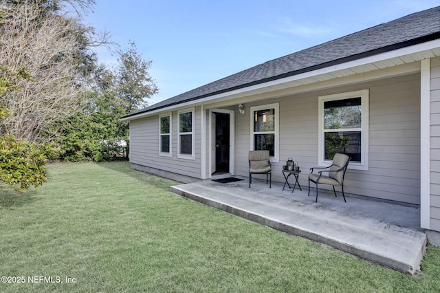 back of house featuring a yard and a patio area