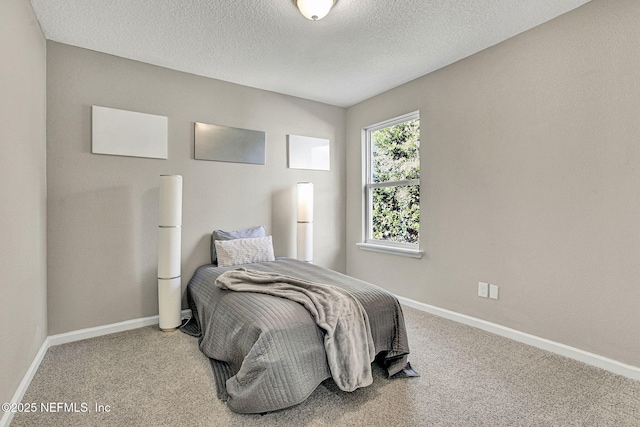 carpeted bedroom with a textured ceiling