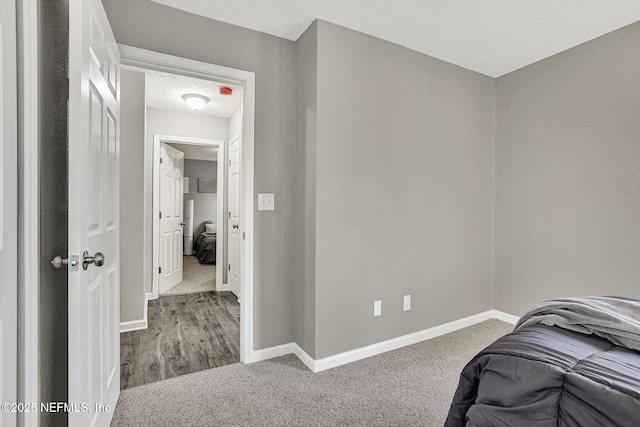 bedroom featuring carpet flooring and a textured ceiling