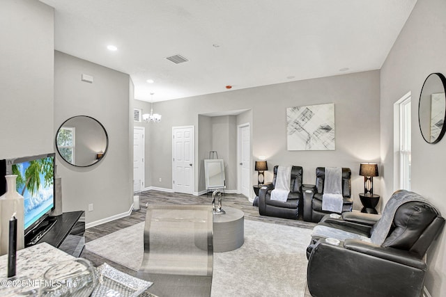 living room with an inviting chandelier and wood-type flooring