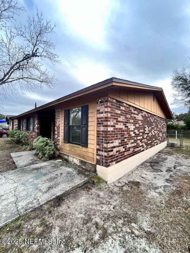 view of side of property featuring a patio area