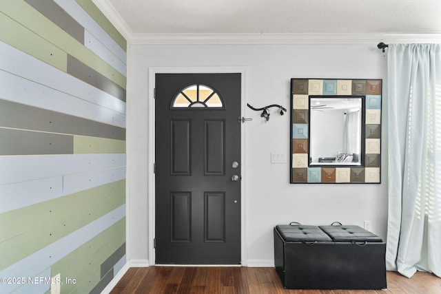 foyer entrance featuring ornamental molding and hardwood / wood-style floors