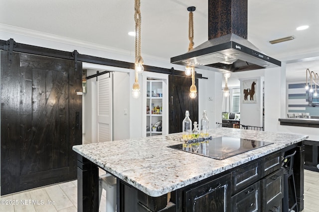 kitchen with a center island with sink, black electric cooktop, ornamental molding, island exhaust hood, and a barn door