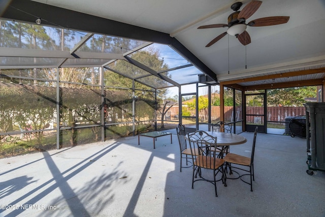 view of patio / terrace featuring ceiling fan and glass enclosure