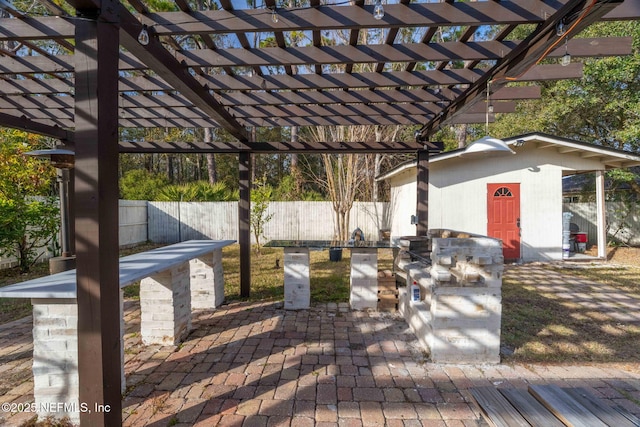 deck featuring a storage shed, a pergola, and a patio