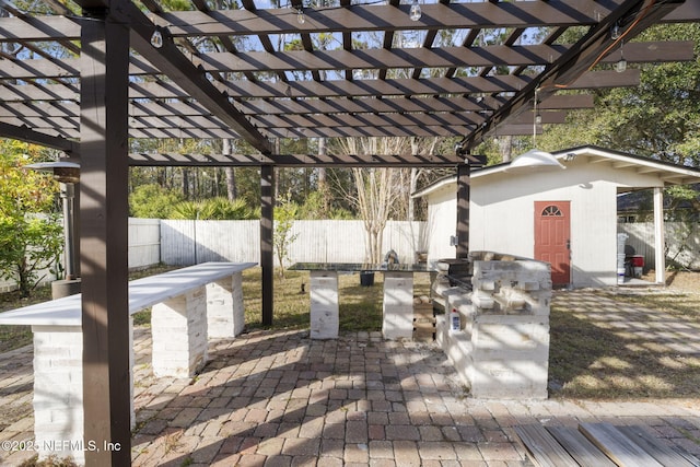 deck with a storage shed, a pergola, and a patio area