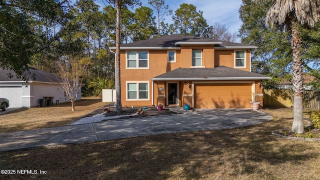 view of front of property featuring a garage and a front lawn