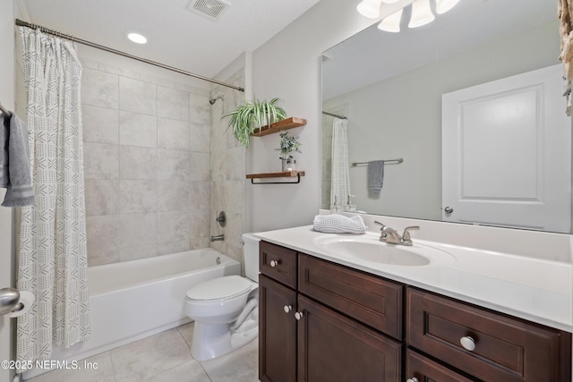 bathroom with shower / tub combo with curtain, visible vents, toilet, vanity, and tile patterned flooring