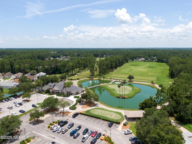 birds eye view of property with view of golf course, a water view, and a forest view