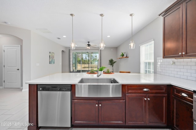 kitchen featuring tasteful backsplash, sink, stainless steel dishwasher, and kitchen peninsula