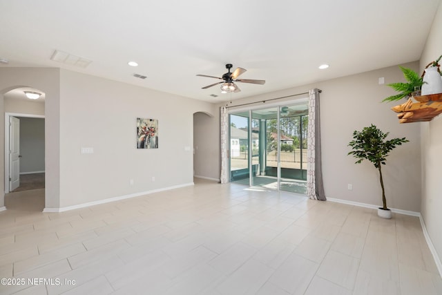 spare room featuring arched walkways, baseboards, a ceiling fan, and recessed lighting