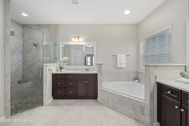 bathroom with vanity, tile patterned flooring, a shower stall, and a bath