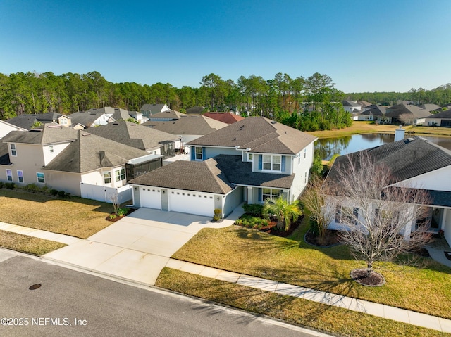 bird's eye view featuring a water view and a residential view