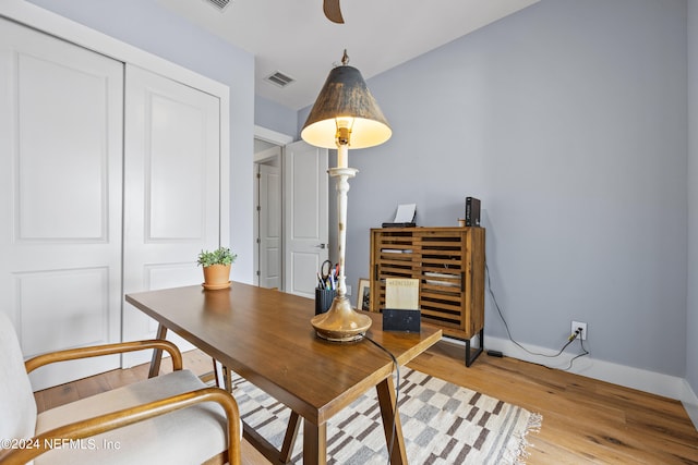 home office with light hardwood / wood-style floors