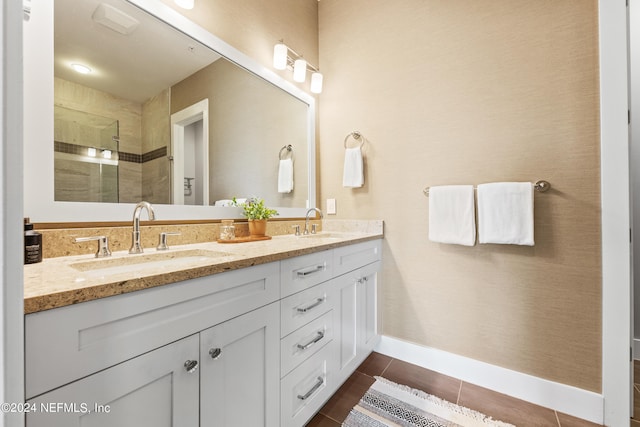 bathroom featuring vanity, a shower with door, and tile patterned flooring