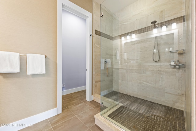 bathroom with tile patterned flooring and walk in shower