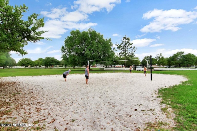 view of property's community with a yard and volleyball court