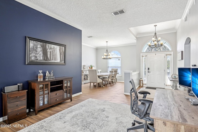 office featuring ornamental molding, hardwood / wood-style floors, a textured ceiling, and an inviting chandelier