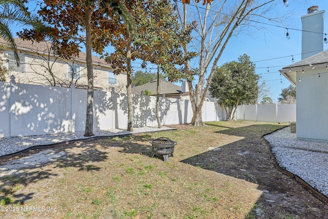 view of yard with an outdoor fire pit