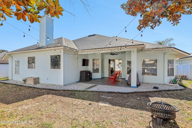 rear view of house featuring a patio, ceiling fan, and an outdoor fire pit