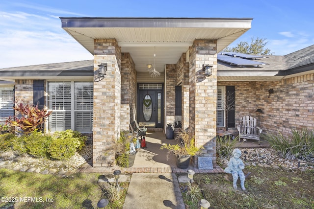 doorway to property featuring solar panels