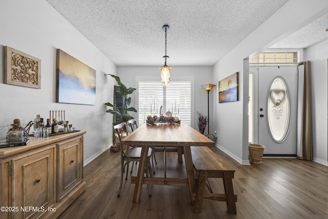 dining area featuring dark hardwood / wood-style flooring and a textured ceiling