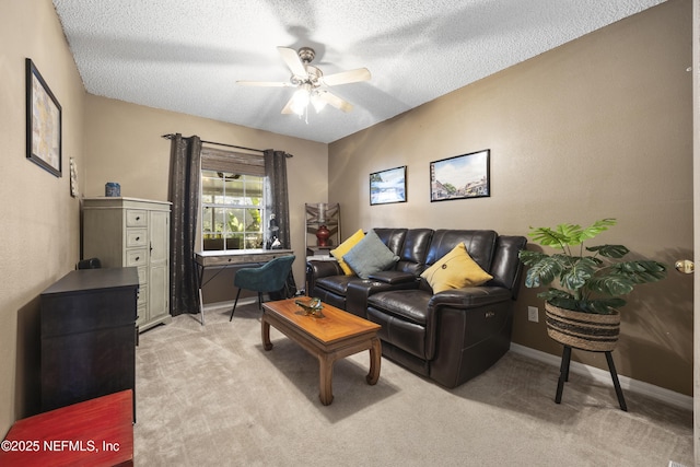 living room with ceiling fan, light carpet, and a textured ceiling