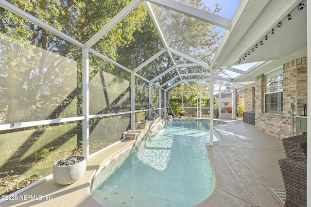 view of pool featuring a patio area and glass enclosure