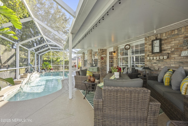 view of patio / terrace with an outdoor hangout area and glass enclosure