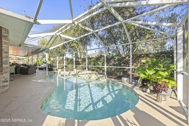 view of swimming pool featuring a patio and a lanai