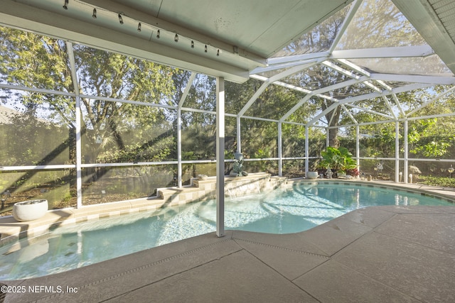 view of swimming pool featuring a lanai and a patio area