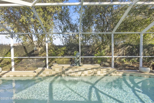 view of pool with glass enclosure