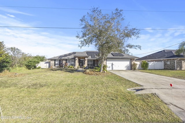 ranch-style home featuring a garage, a front yard, and solar panels