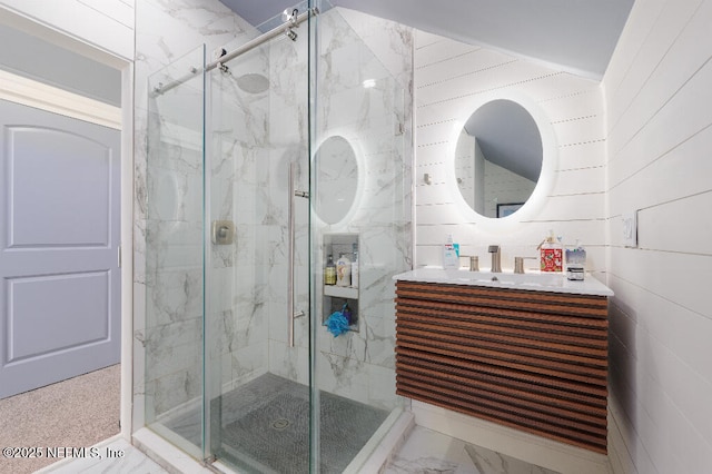 bathroom with marble finish floor, a marble finish shower, and vanity