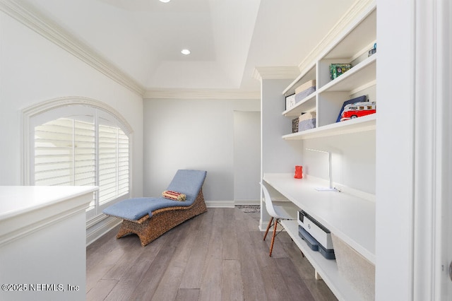 living area featuring a tray ceiling, crown molding, recessed lighting, wood finished floors, and baseboards