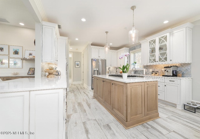 kitchen with white cabinets, glass insert cabinets, and light countertops