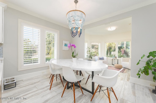 dining area with a healthy amount of sunlight, baseboards, and ornamental molding