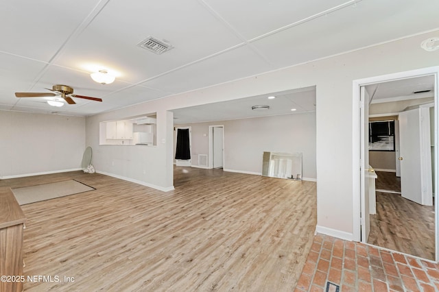 basement with ceiling fan and hardwood / wood-style floors