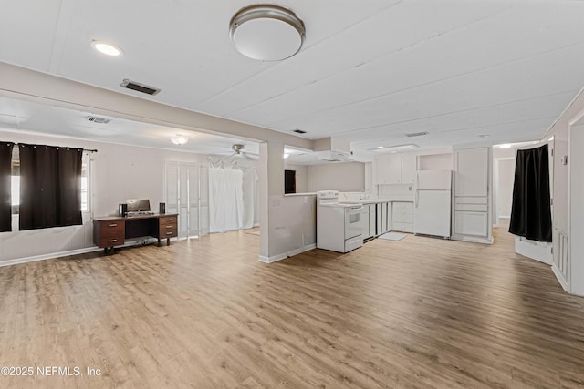 unfurnished living room featuring ceiling fan and light hardwood / wood-style floors